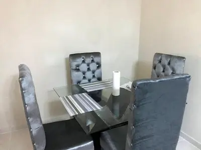 a glass table with two chairs and a candle on it at La maravilla y comodidad al máximo in La Javilla