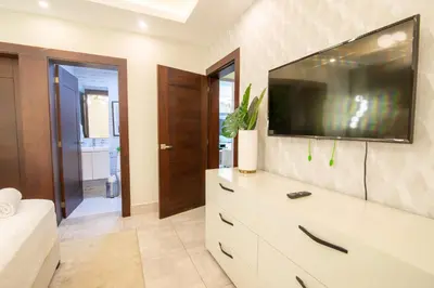 a white dresser with a television on top of it at Exclusivo apartamento - Soha Suites II-B9 - 2 BR in Rincón Largo
