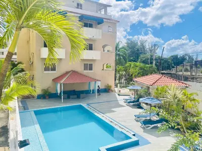 a hotel with a swimming pool next to a building at Apartamento en la playa 1A - Residencial Marina Bay in Cuevas