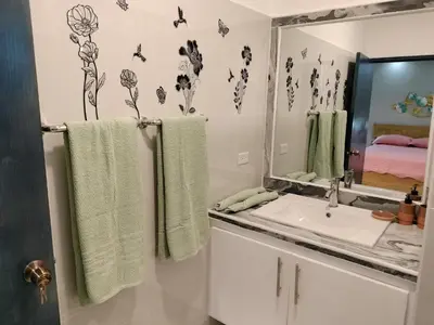 a bathroom with a sink and a mirror and towels at Agréable appartement en rooftop in La Cabirma