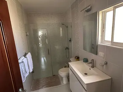a bathroom with a shower and a toilet and a sink at Casa completa con hermosa vista in San Felipe de Puerto Plata