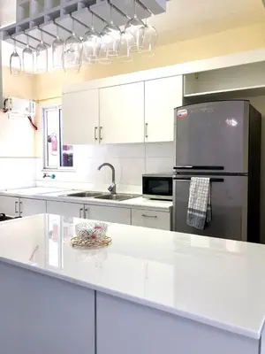 a kitchen with white cabinets and a stainless steel refrigerator at Hidden Paradise in La Grúa