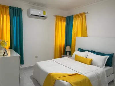 a bedroom with a large bed with colorful curtains at Hidden Paradise in La Grúa