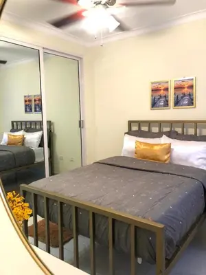 a bedroom with a bed and a mirror at Hidden Paradise in La Grúa