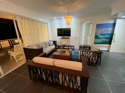 a living room with a couch and a table at Ocean Front Deluxe Condo in Punta Balandra