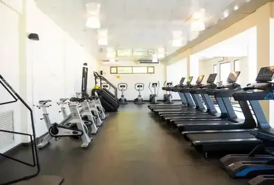 a gym with a row of treadmills and machines at Timeless Luxury Villa-Ocean View 3BRM-5Bath-Pool in San Felipe de Puerto Plata