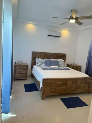 a bedroom with a bed and a ceiling fan at Timeless Luxury Villa-Ocean View 3BRM-5Bath-Pool in San Felipe de Puerto Plata