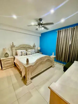 a bedroom with a bed and a ceiling fan at LasOlasTower JuanDolio-2Br-3Bds-7Px-WiFi-SeaView in Juan Dolio