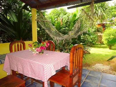 a table and chairs with a pink and white table cloth at La Rancheta in Las Galeras