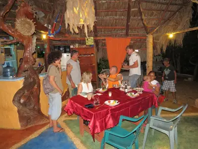 a group of people standing around a table at La Rancheta in Las Galeras