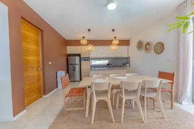 a kitchen and dining room with a table and chairs at Villa Chocolate in Laguna del Higüero