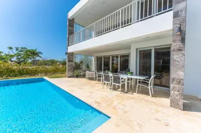 a house with a swimming pool and a table and chairs at Villa Chocolate in Laguna del Higüero