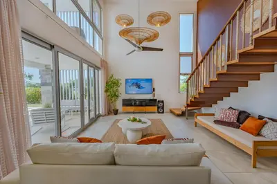a living room with a couch and a staircase at Villa Chocolate in Laguna del Higüero