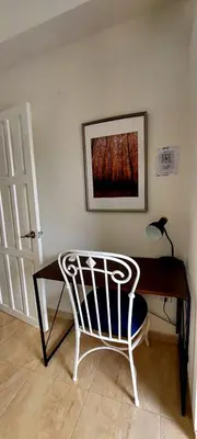 a desk with a chair and a lamp and a picture at Salomé in Sans Souci
