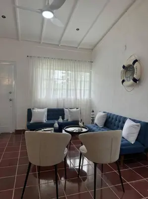 a living room with a blue couch and chairs at Luz de Luna Emotions in Santo Domingo