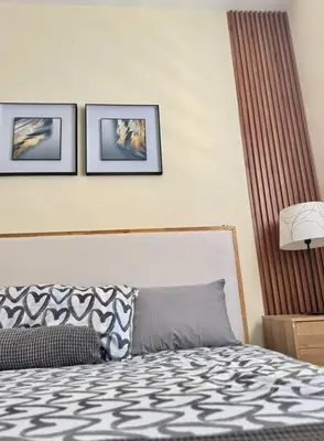 a bedroom with a bed and three pictures on the wall at Apartamento hermoso in Los Macos