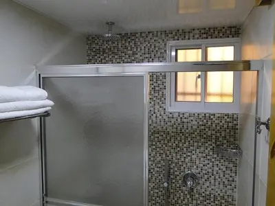 a shower with a glass door in a bathroom at Apartamento Carmil I in Santo Domingo