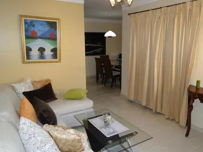a living room with a couch and a table at Apartamento Carmil I in Santo Domingo