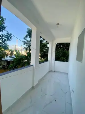 an empty room with two windows in a building at Fantástico apartamento céntrico Playa a 100 mts in Río San Juan