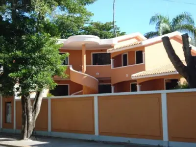 a orange house with a fence and trees at Residenzia Oasis Fiordaliza in El Higo