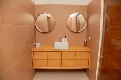 a bathroom with a sink and two mirrors on the wall at Vistas Galeras in Madama
