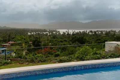a swimming pool with a view of the water at Vistas Galeras in Madama