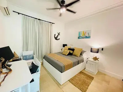 a bedroom with a bed and a ceiling fan at Victorian Condominio in Cabarete