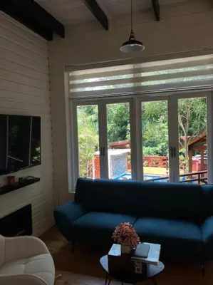 a living room with a blue couch in front of a window at Villa Reina in Buena Vista