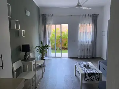 a white living room with a table and chairs at Eden 07 08 in La Laguna