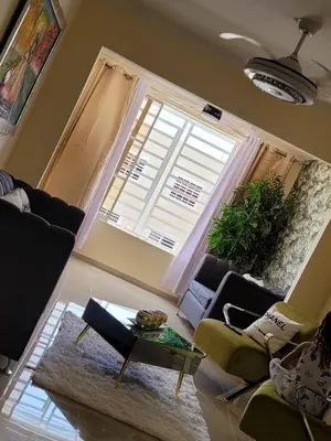 a living room with a couch and a large window at Elegante apartamento en San isidro in Mendoza