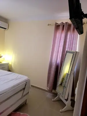 a bedroom with a mirror next to a bed at Elegante apartamento en San isidro in Mendoza