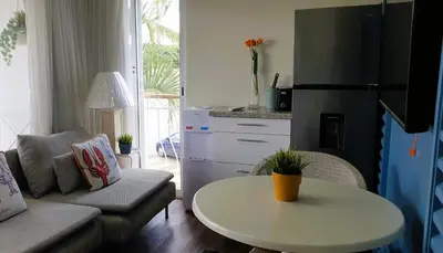 a living room with a couch and a table at Cadaques Caribe Bayahibe Private beach in Bayahibe