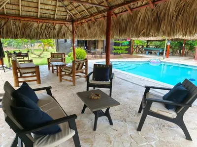 a patio with chairs and a swimming pool at Villa Doña Plinia in El Cruce