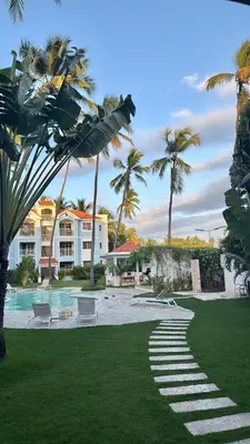 a resort with palm trees and a swimming pool at Beautiful Place in los Corales bavaro in Punta Cana