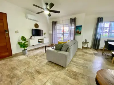 a living room with a couch and a ceiling fan at Beautiful Place in los Corales bavaro in Punta Cana