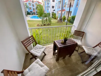 a balcony with a table and chairs and a view at Beautiful Place in los Corales bavaro in Punta Cana
