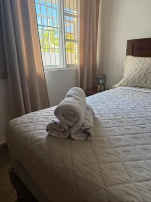 a bedroom with a bed with towels on it at Beautiful Place in los Corales bavaro in Punta Cana