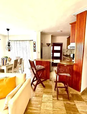 a living room with a couch and a kitchen at Beautiful Place in los Corales bavaro in Punta Cana