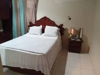a bedroom with a large bed with white sheets and pillows at 501 Apto Entero Stunning Malecón Roof Condo in Villa Francisca