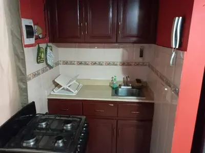 a small kitchen with a stove and a sink at 501 Apto Entero Stunning Malecón Roof Condo in Villa Francisca