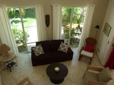 a living room with a couch and a table at Charming oceanside 2 bd villa in Cabarete