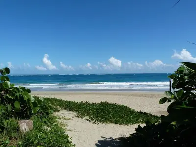a sandy beach with the ocean in the background at Charming oceanside 2 bd villa in Cabarete