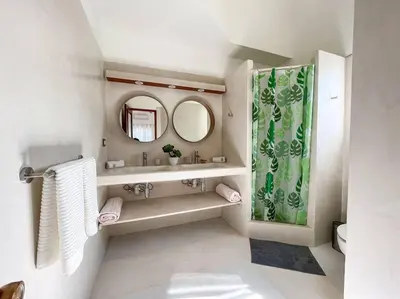a bathroom with a sink and a mirror at Charming oceanside 2 bd villa in Cabarete