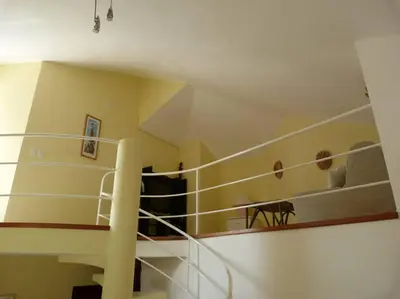 a group of people sitting on the second floor of a building at Charming oceanside 2 bd villa in Cabarete