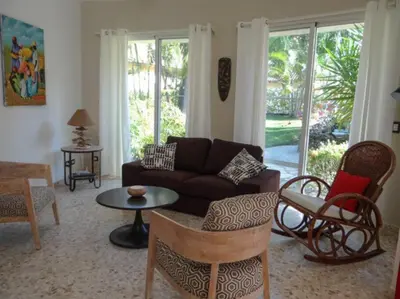 a living room with a couch and chairs and a table at Charming oceanside 2 bd villa in Cabarete