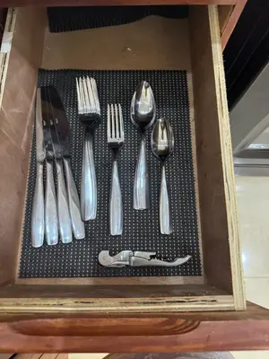 a drawer with utensils in a wooden box at Casa las América in La Cana
