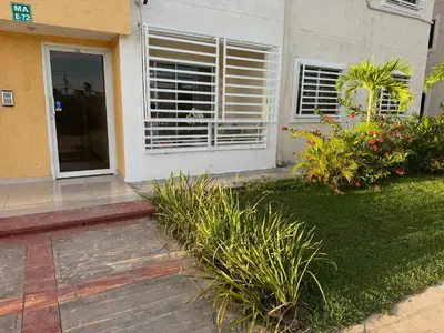 a house with a window with blinds on it at Casa las América in La Cana