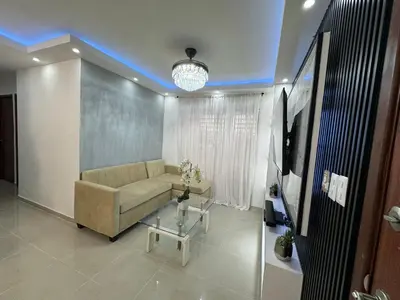a living room with a couch and a tv at Casa las americas in La Cana