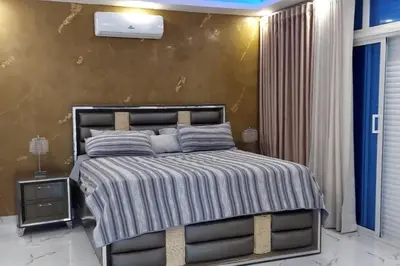 a bedroom with a large bed in a room at Bocachica house,apts,village in Jubey