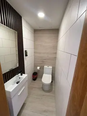 a bathroom with a white toilet and a sink at Departamento de lujo en Santo Domingo in Santo Domingo